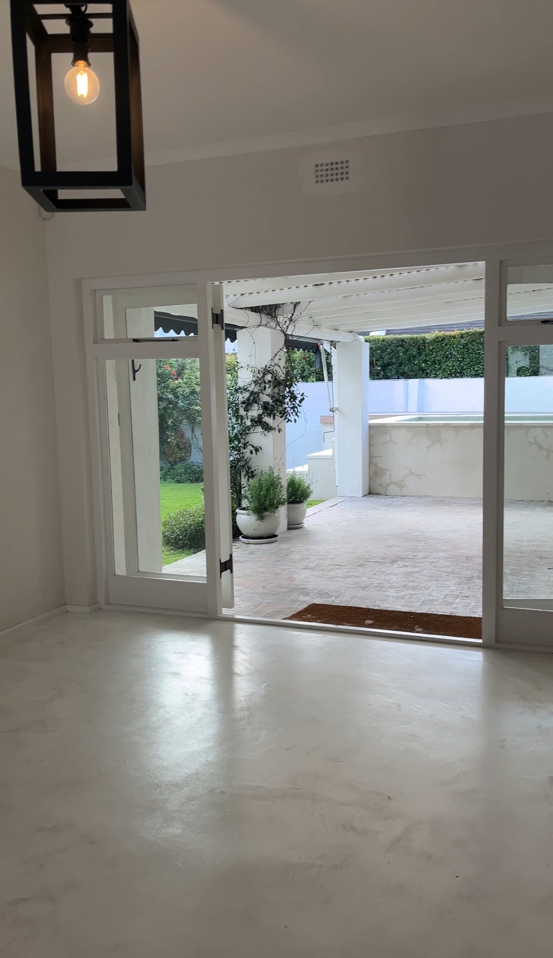 Screed floor living space opening onto the covered patio and pool