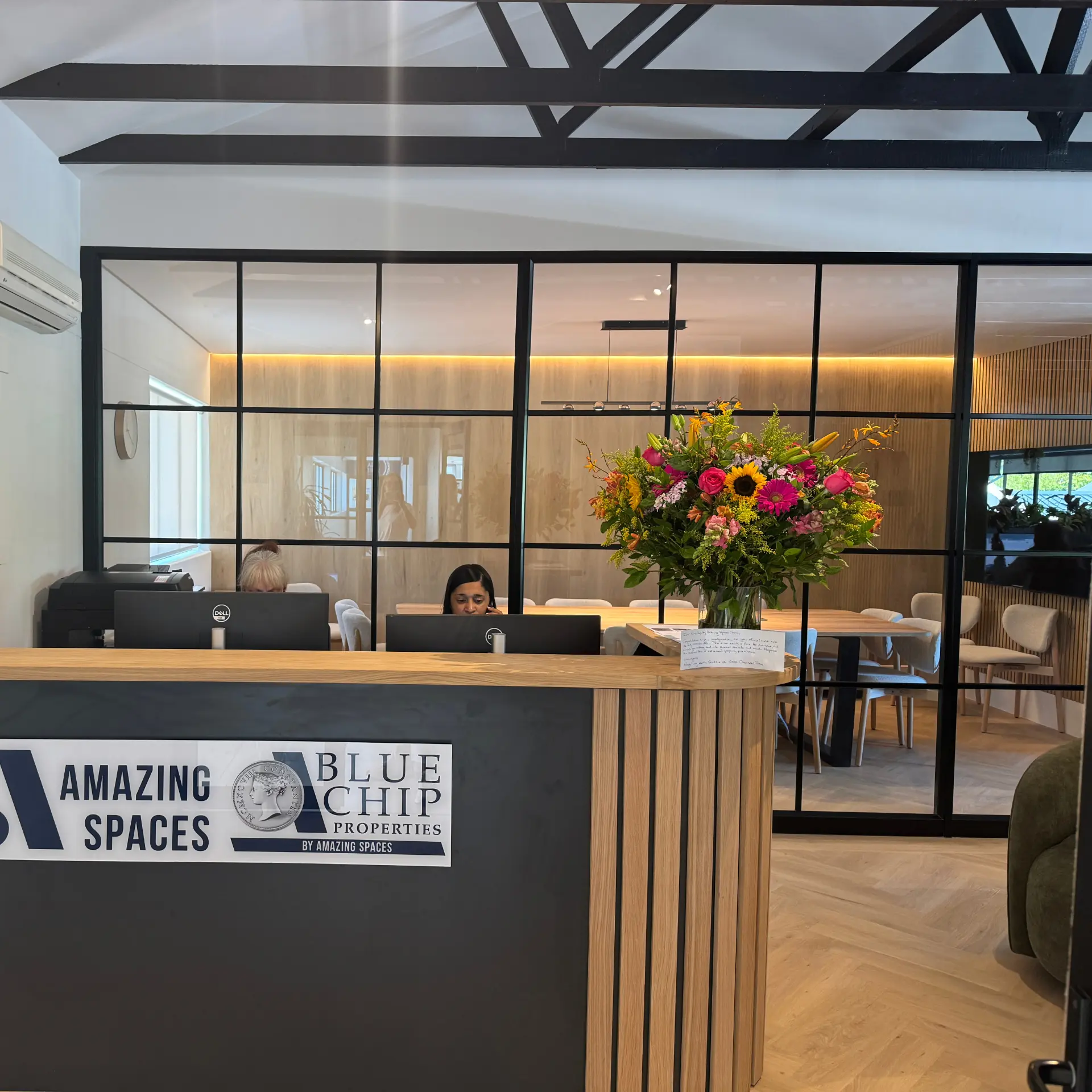 Reception desk in oak fluting with meeting room beyond