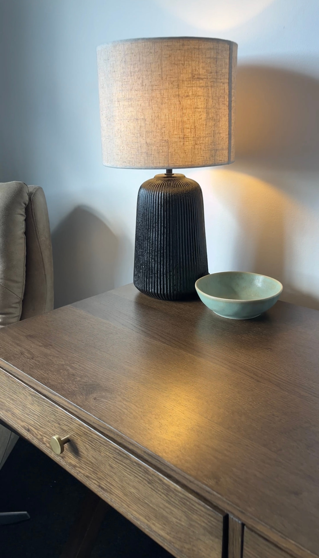Ribbed ceramic lamp and celadon bowl on an oak writing desk